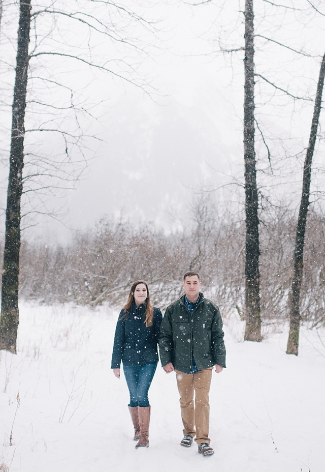 snowy alaska engagement photos in the woods