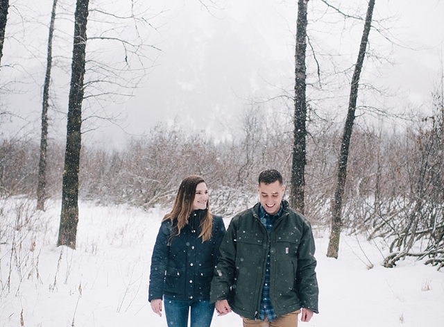 snowy alaska engagement photos in the woods