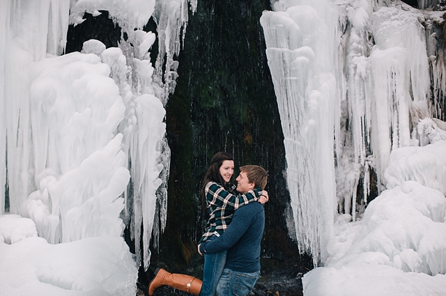 alaska winter engagement photos by a frozen waterfall